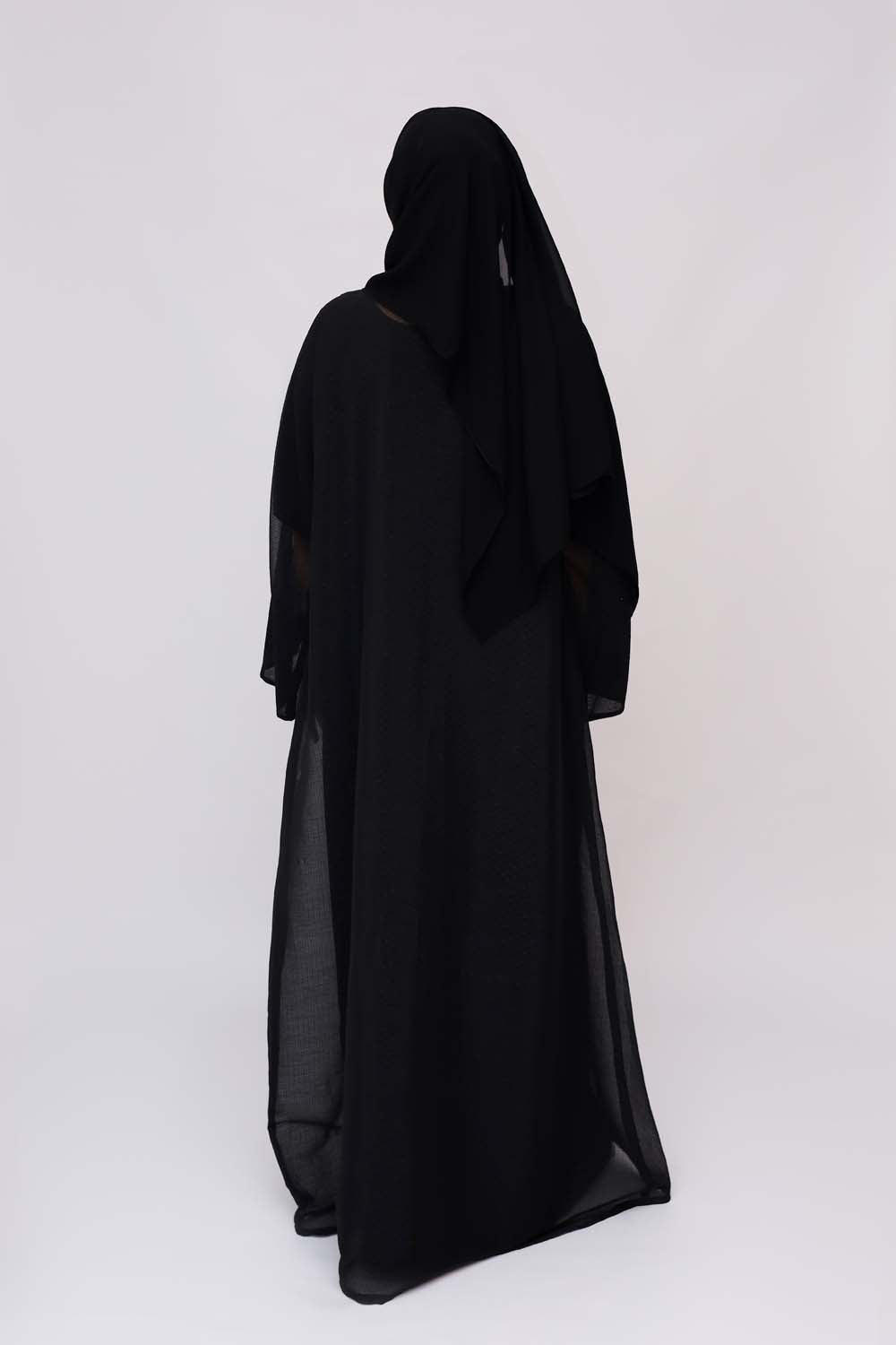 "Elegant Black Abaya with Front Beads Work showcased on a 5.6 feet model, blending traditional modesty with contemporary style."