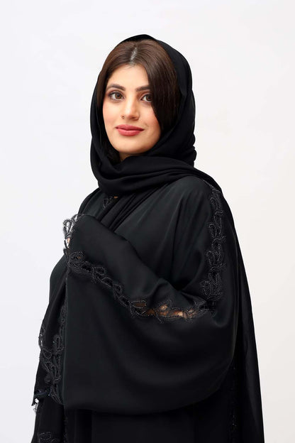 "Elegant Black Beads Cutwork Abaya showcased on a 5.6 feet model, featuring intricate details and sophisticated bead embellishments."