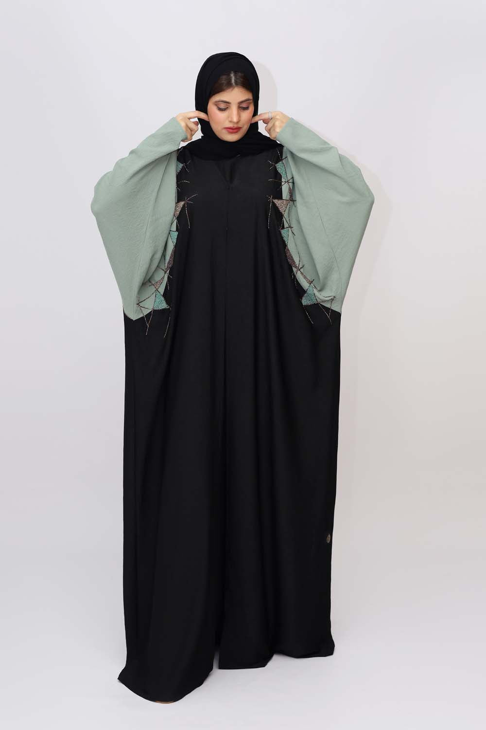 "Elegant Kaftan Style Beads Work Abaya showcased on a 5.6 feet model, blending traditional charm with modern sophistication. Model wears size 56."