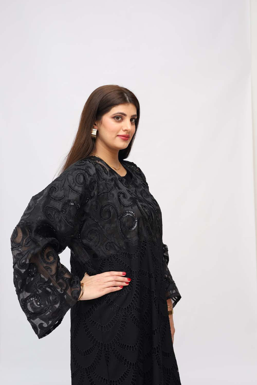 "Elegant Chickenkari Net Style Abaya showcased on a 5.6 feet model, featuring feminine embroidery and a tailored fit. Model wears size 56."