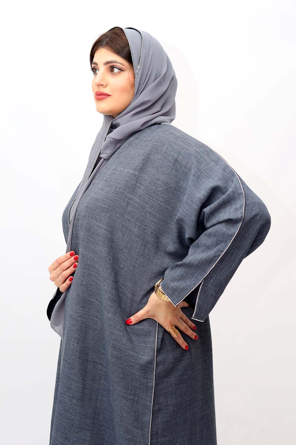 "Elegant Grey Stones Work Abaya showcased on a 5.6 feet model, featuring intricate stone embellishments and a tailored fit. Model wears size 56."