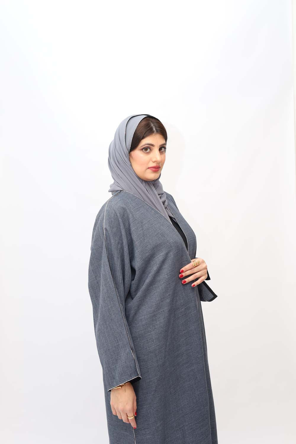 "Elegant Grey Stones Work Abaya showcased on a 5.6 feet model, featuring intricate stone embellishments and a tailored fit. Model wears size 56."