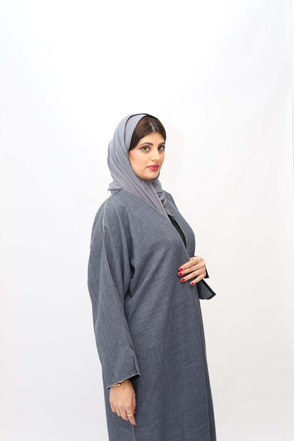 "Elegant Grey Stones Work Abaya showcased on a 5.6 feet model, featuring intricate stone embellishments and a tailored fit. Model wears size 56."