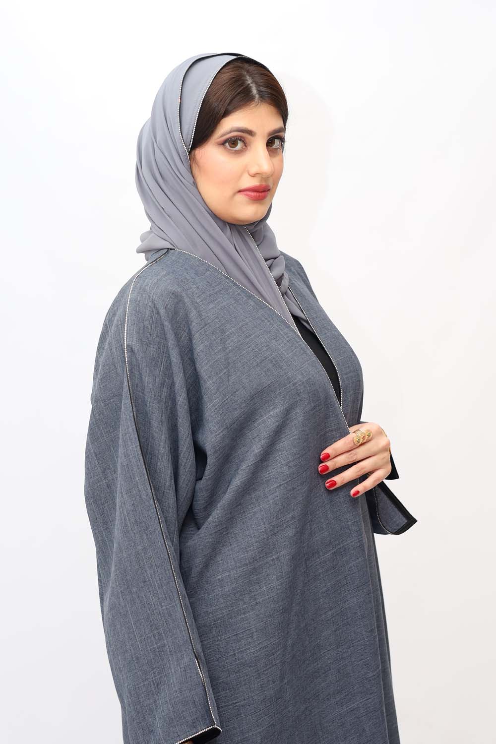 "Elegant Grey Stones Work Abaya showcased on a 5.6 feet model, featuring intricate stone embellishments and a tailored fit. Model wears size 56."