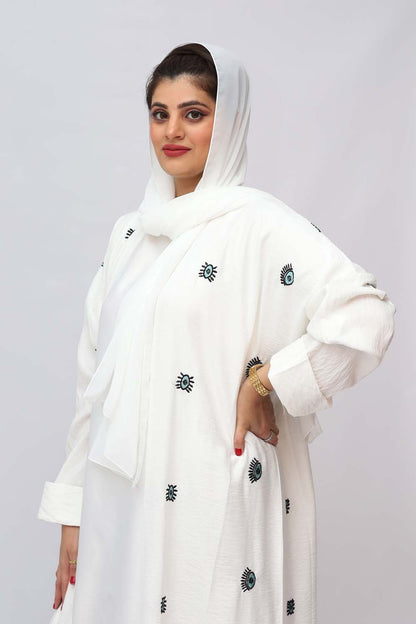 "Elegant White Embroidery Abaya showcased on a 5.6 feet model, featuring intricate detailing and a tailored fit. Model wears size 56."