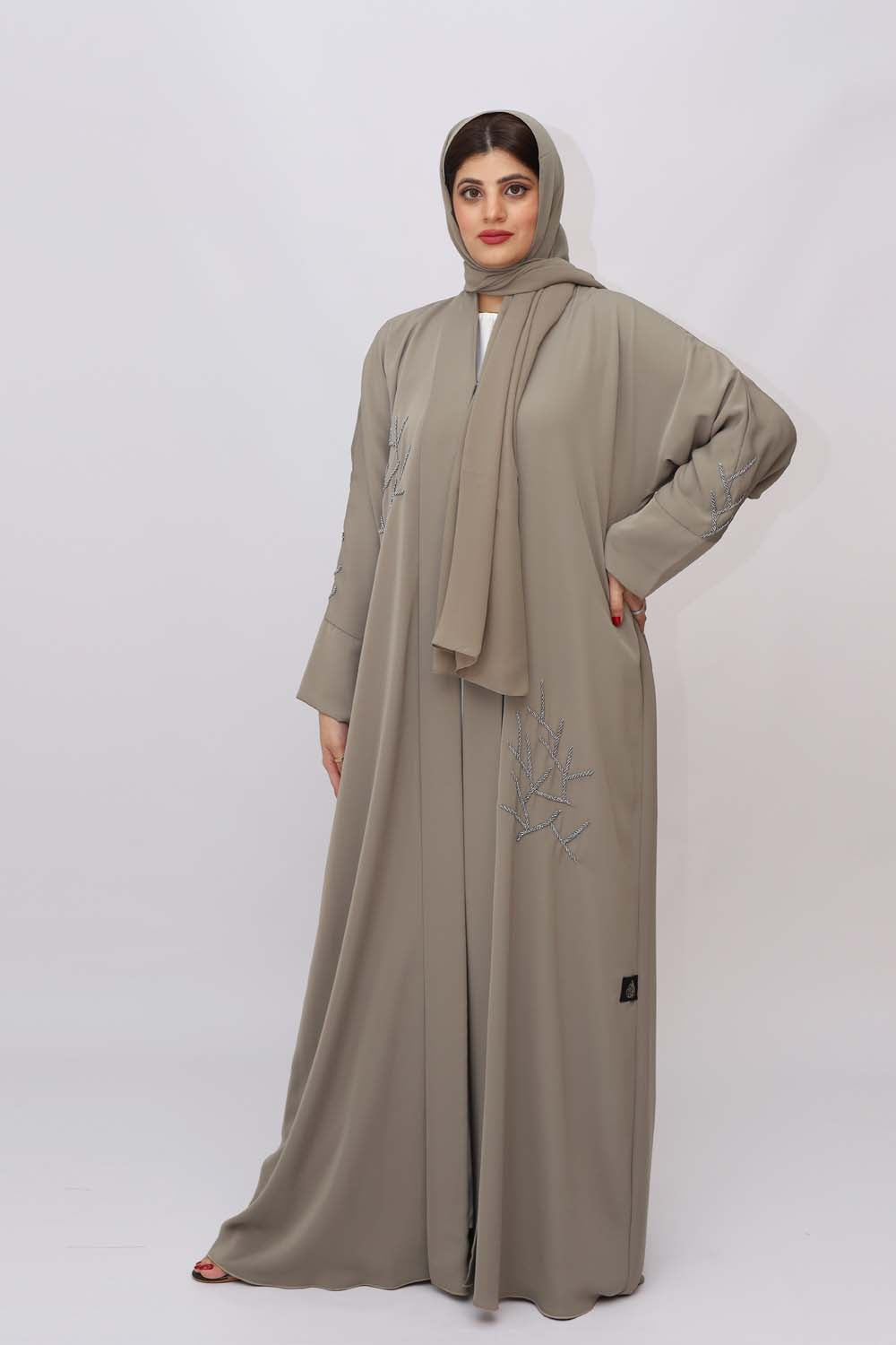 "Elegant Handmade Beads Work Abaya showcased on a 5.6 feet model, featuring exquisite bead detailing and a tailored fit. Model wears size 56."